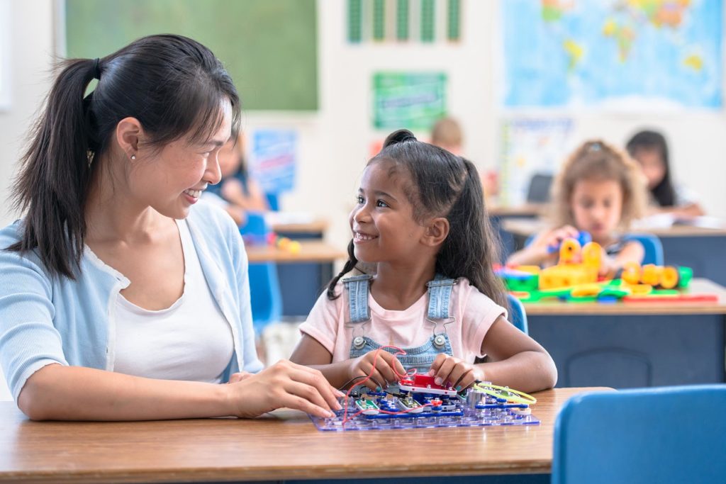 teacher helping student with STEM project